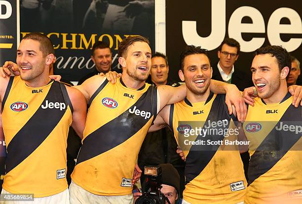 Brett Deledio of the Richmond Tigers sings the team song in the changing rooms after the round 22 AFL match between the Essendon Bombers and the...