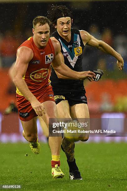 Brandon Matera of the Suns competes for the ball with Jasper Pittard of the Power during the round 22 AFL match between the Gold Coast Suns and the...