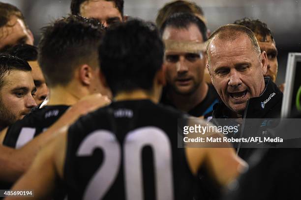 Coach Ken Hinkley of the Power speaks to his players during the round 22 AFL match between the Gold Coast Suns and the Port Adelaide Power at...