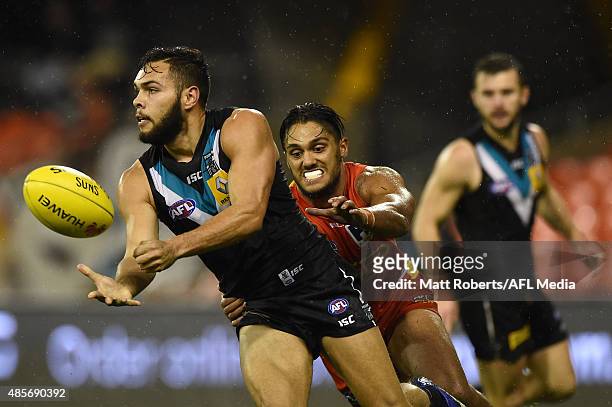 Jarman Impey of the Power handballs under pressure during the round 22 AFL match between the Gold Coast Suns and the Port Adelaide Power at Metricon...