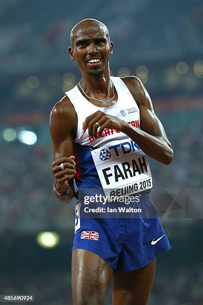 Mohamed Farah of Great Britain celebrates after crossing the finish line to win gold in the Men's 5000 metres final during day eight of the 15th IAAF...