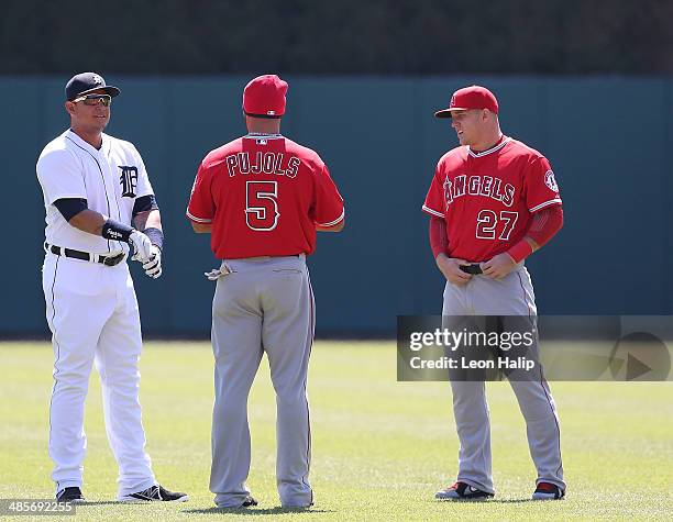 Miguel Cabrera of the Detroit Tigers and Albert Pujols and Mike Trout of the Los Angeles Angels of Anaheim talk in centerfield prior to the start of...