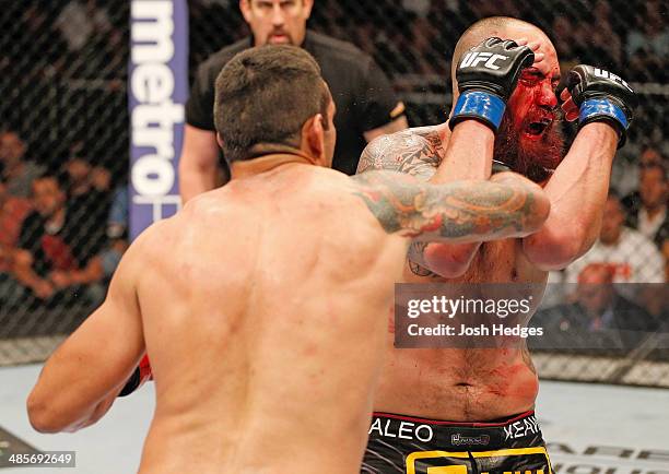 Fabricio Werdum punches Travis Browne in their heavyweight bout during the FOX UFC Saturday event at the Amway Center on April 19, 2014 in Orlando,...