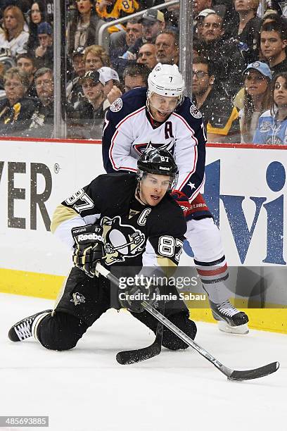 Sidney Crosby of the Pittsburgh Penguins controls the puck from his knees as Jack Johnson of the Columbus Blue Jackets defends in the first overtime...