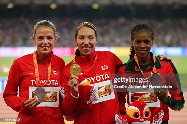 Silver medalist Melissa Bishop of Canada, gold medalist Marina Arzamasova of Belarus and bronze medalist Eunice Jepkoech Sum of Kenya pose on the...