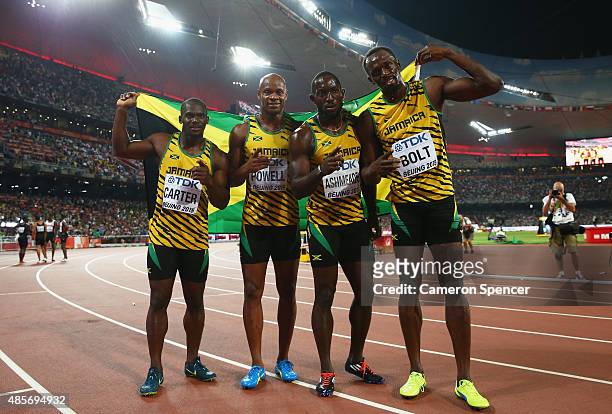 Nickel Ashmeade of Jamaica, Asafa Powell of Jamaica, Usain Bolt of Jamaica of Jamaica and Nesta Carter of Jamaica celebrate after winning gold in the...