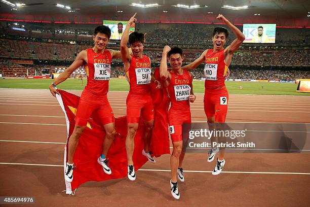 Bingtian Su of China, Zhenye Xie of China, Peimeng Zhang of China and Youxue Mo of China celebrate after winning silver in the Men's 4x100 Metres...