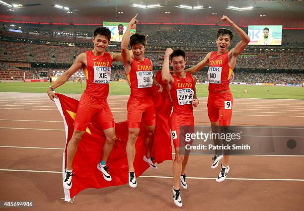 Bingtian Su of China, Zhenye Xie of China, Peimeng Zhang of China and Youxue Mo of China celebrate after winning silver in the Men's 4x100 Metres...