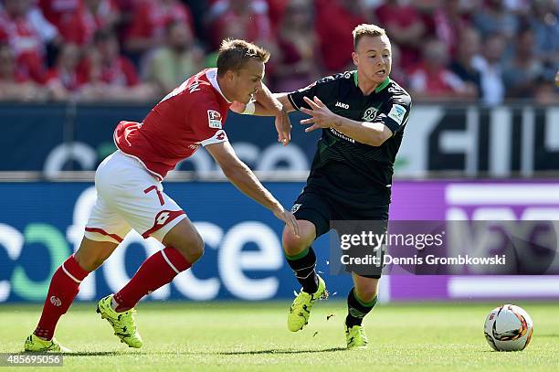 Pierre Bengtsson of 1. FSV Mainz 05 challenges Uffe Bech of Hannover 96 during the Bundesliga match between 1. FSV Mainz 05 and Hannover 96 at Coface...