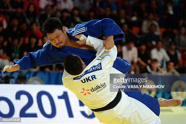 Ukraines Iakiv Khammo competes with South Koreas Kim Sung-Min during the mens bronze medal match, in the +100kg category at the Judo World...