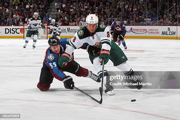 Cody McCormick the Minnesota Wild skates with the puck as Cody McLeod of the Colorado Avalanche challenges in Game Two of the First Round of the 2014...