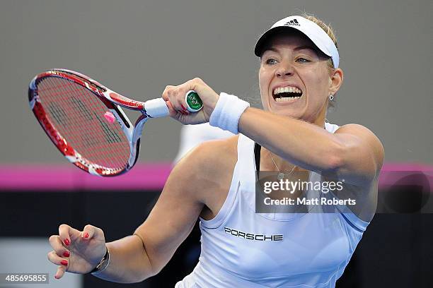 Angelique Kerber of Germany plays a forehand shot against Samantha Stosur of Australia during the Fed Cup Semi Final tie between Australia and...