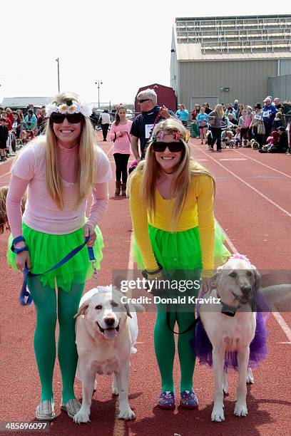 Emily Conover and Lilu a Labradoodle with sister Hayley and Roxy a Yellow Lab from Ocean City, NJ attends the 2014 Woofin' Paws Pet Fashion Show at...