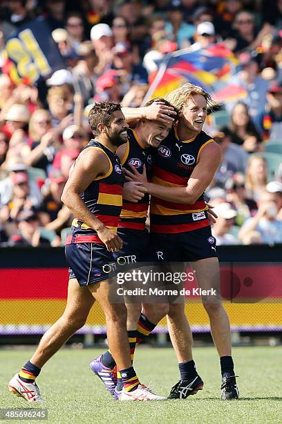 Jared Patrenko, Patrick Dangerfield and Rory Sloane of the Crows celebrate a goal by Dangerfield during the round five AFL match between the Adelaide...