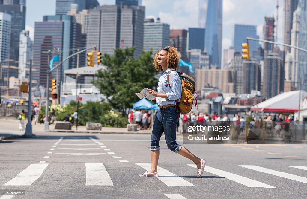 African American woman tourist holding a map in New York