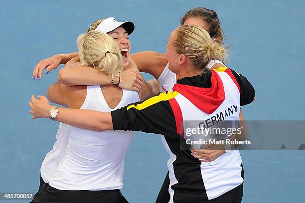 Angelique Kerber of Germany celebrates victory with team-mates after her match against Samantha Stosur of Australia during the Fed Cup Semi Final tie...