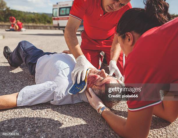 medical emergency team arrives at street accident - gory car accident photos stock pictures, royalty-free photos & images