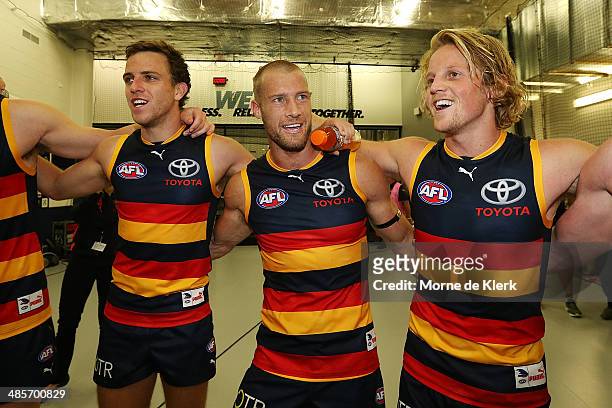 Brodie Smith, Scott Thompson and Rory Sloane of the Crows celebrate in the rooms after the round five AFL match between the Adelaide Crows and the...