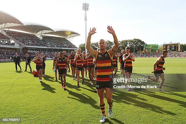 Scott Thompson of the Crows leads the team from the field after his 250th game after the round five AFL match between the Adelaide Crows and the...