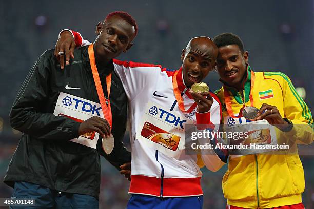 Silver medalist Caleb Mwangangi Ndiku of Kenya, gold medalist Mohamed Farah of Great Britain and bronze Hagos Gebrhiwet of Ethiopia pose on the...