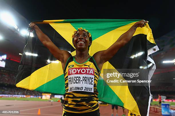 Shelly-Ann Fraser-Pryce of Jamaica celebrates after crossing the finish line to win gold in the Women's 4x100 Metres Relay final during day eight of...