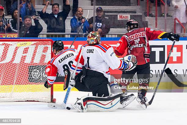 Jacob Micflikier of Lulea Hockey gets the puck in goal behind Benjamin Conz Goaltender of Fribourg-Gotteron during the Champions Hockey League group...