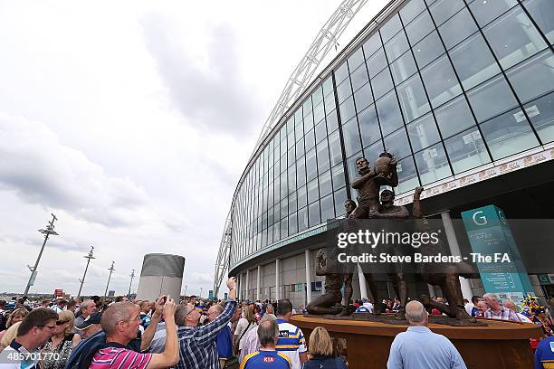 Supporters congregate around the recently unveiled Rugby League Legends statue prior to the Ladbrokes Challenge Cup Final between Leeds Rhinos and...