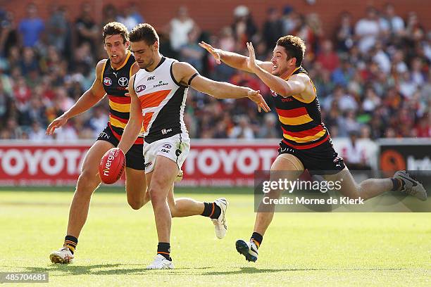 Stephen Coniglio of the Giants gets away from Matthew Jaensch of the Crows during the round five AFL match between the Adelaide Crows and the Greater...