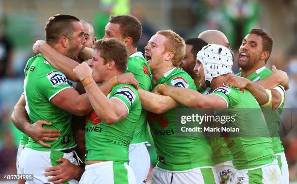 Paul Vaughan of the Raiders celebrates with team mates after scoring the match winning try during the round seven NRL match between the Canberra...