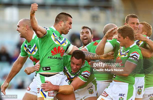 Paul Vaughan of the Raiders celebrates with team mates after scoring the match winning try during the round seven NRL match between the Canberra...