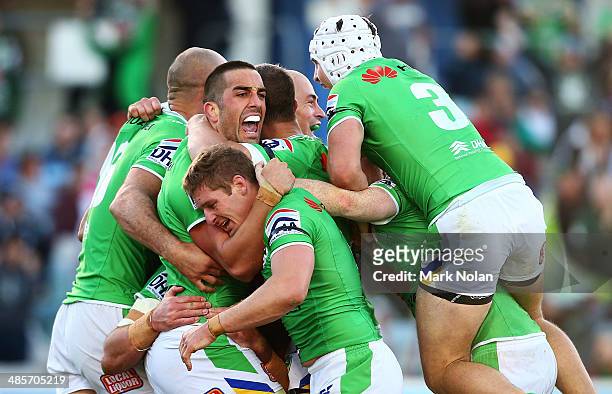 Paul Vaughan of the Raiders celebrates with team mates after scoring the match winning try during the round seven NRL match between the Canberra...