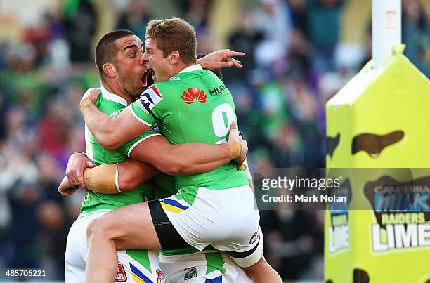 Paul Vaughan of the Raiders celebrates with team mate Glen Buttriss after scoring the match winning try during the round seven NRL match between the...