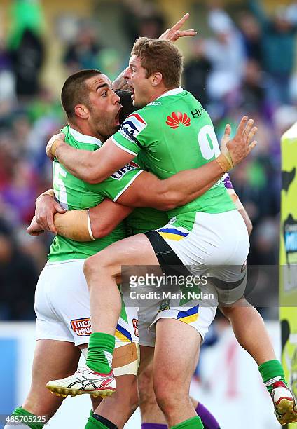 Paul Vaughan of the Raiders celebrates with team mate Glen Buttriss after scoring the match winning try during the round seven NRL match between the...