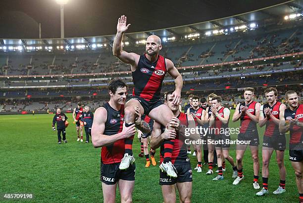 Paul Chapman of the Essendon Bombers is chaired from the field after plaing his final match during the round 22 AFL match between the Essendon...