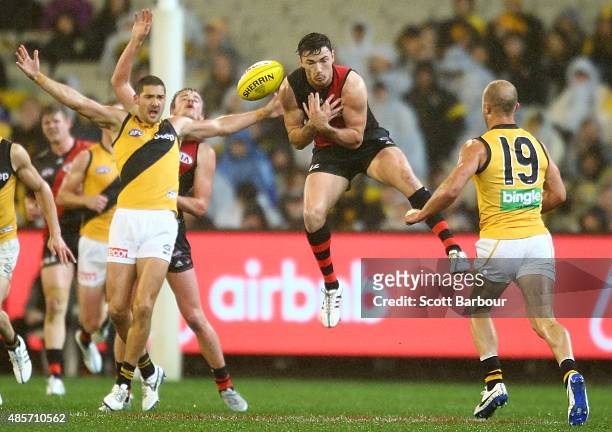 Michael Hibberd of the Essendon Bombers competes for the ball during the round 22 AFL match between the Essendon Bombers and the Richmond Tigers at...