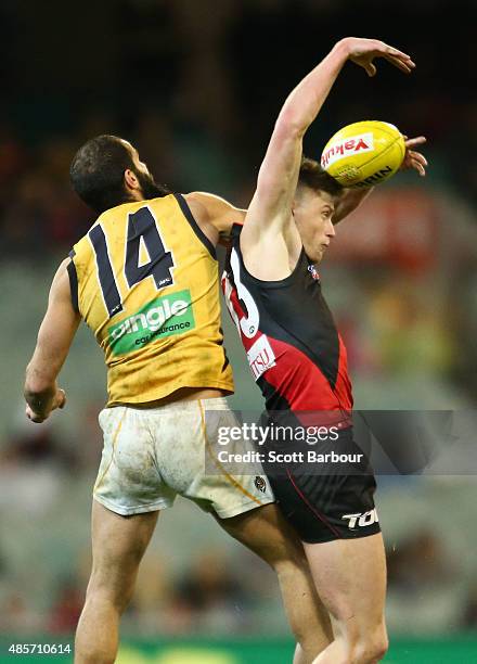 Jayden Laverde of the Essendon Bombers and Bachar Houli of the Richmond Tigers compete for the ball during the round 22 AFL match between the...