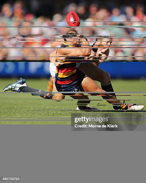 Jonathan Giles of the Giants tackles Kyle Hartigan of the Crows during the round five AFL match between the Adelaide Crows and the Greater Western...