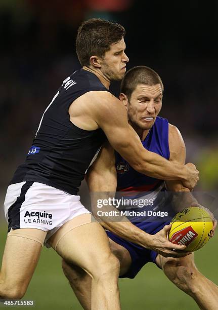 Marc Murphy of the Blues tackles Matthew Boyd of the Bulldogs during the round five AFL match between the Western Bulldogs and the Carlton Blues at...