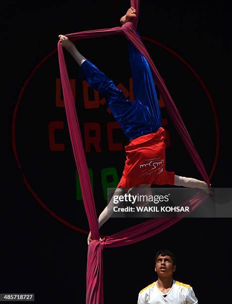 Afghan children from The Mobile Mini Circus for Children perform during a circus show in Kabul on April 20, 2014. Children from The Mobile Mini...