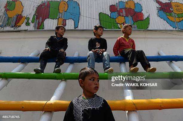 Afghan children watch a performance of The Mobile Mini Circus for Children in Kabul on April 20, 2014. Children from The Mobile Mini Circus for...