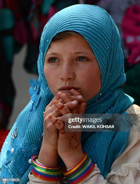 An Afghan child watches a performance of The Mobile Mini Circus for Children in Kabul on April 20, 2014. Children from The Mobile Mini Circus for...