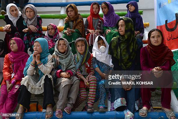 Afghan children watch a performance of The Mobile Mini Circus for Children in Kabul on April 20, 2014. Children from The Mobile Mini Circus for...