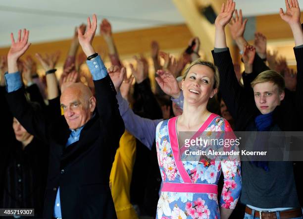 Martin Kind, President of German soccer club Hannover 96 and wife of former German President, Bettina Wulff, cheer during a special Easter church...