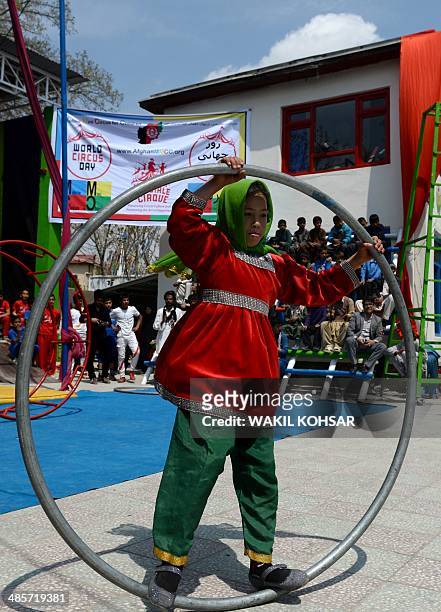 An Afghan children of The Mobile Mini Circus for Children performs in Kabul on April 20, 2014. Children from The Mobile Mini Circus for Children...
