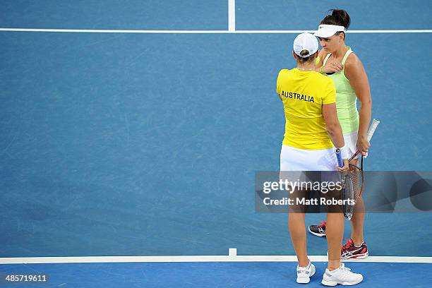 Ashleigh Barty and Casey Dellacqua of Australia talk tactics in their doubles match against Anna-Lena Groenefeld and Julia Goerges of Germany during...