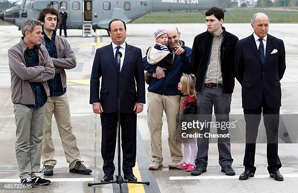 French President Francois Hollande, with foreign minister, Laurent Fabius, flanked by the four French journalists, , Didier Francois, Edouard Elias,...