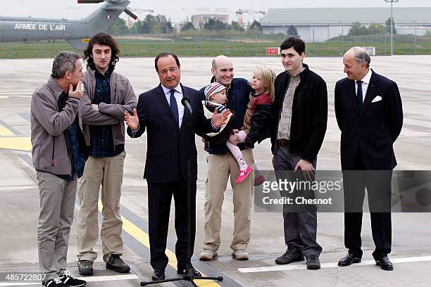 French President Francois Hollande, with foreign minister, Laurent Fabius, flanked by the four French journalists, , Didier Francois, Edouard Elias,...