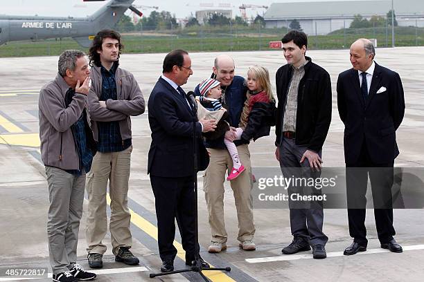 French President Francois Hollande, with foreign minister, Laurent Fabius, flanked by the four French journalists, , Didier Francois, Edouard Elias,...