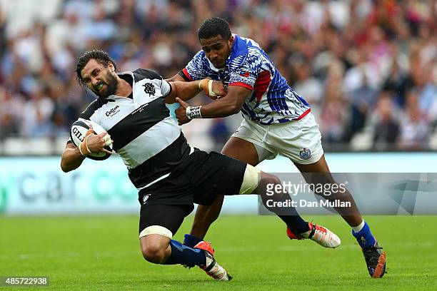 Jaques Potgieter of The Barbarians is tackled by Reynold Lee-Lo of Samoa during the International Friendly match between The Barbarians and Samoa at...