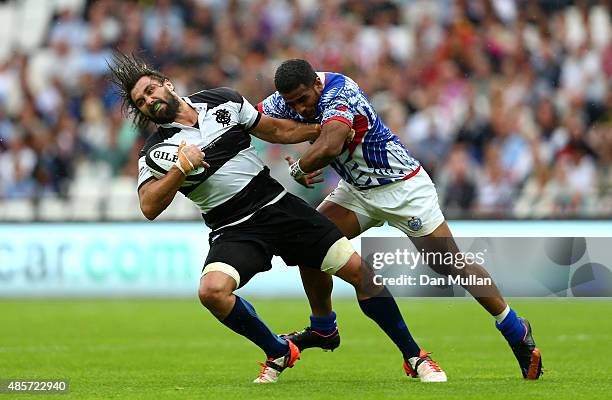 Jaques Potgieter of The Barbarians is tackled by Reynold Lee-Lo of Samoa during the International Friendly match between The Barbarians and Samoa at...